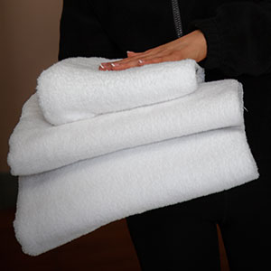maid with pile of towels